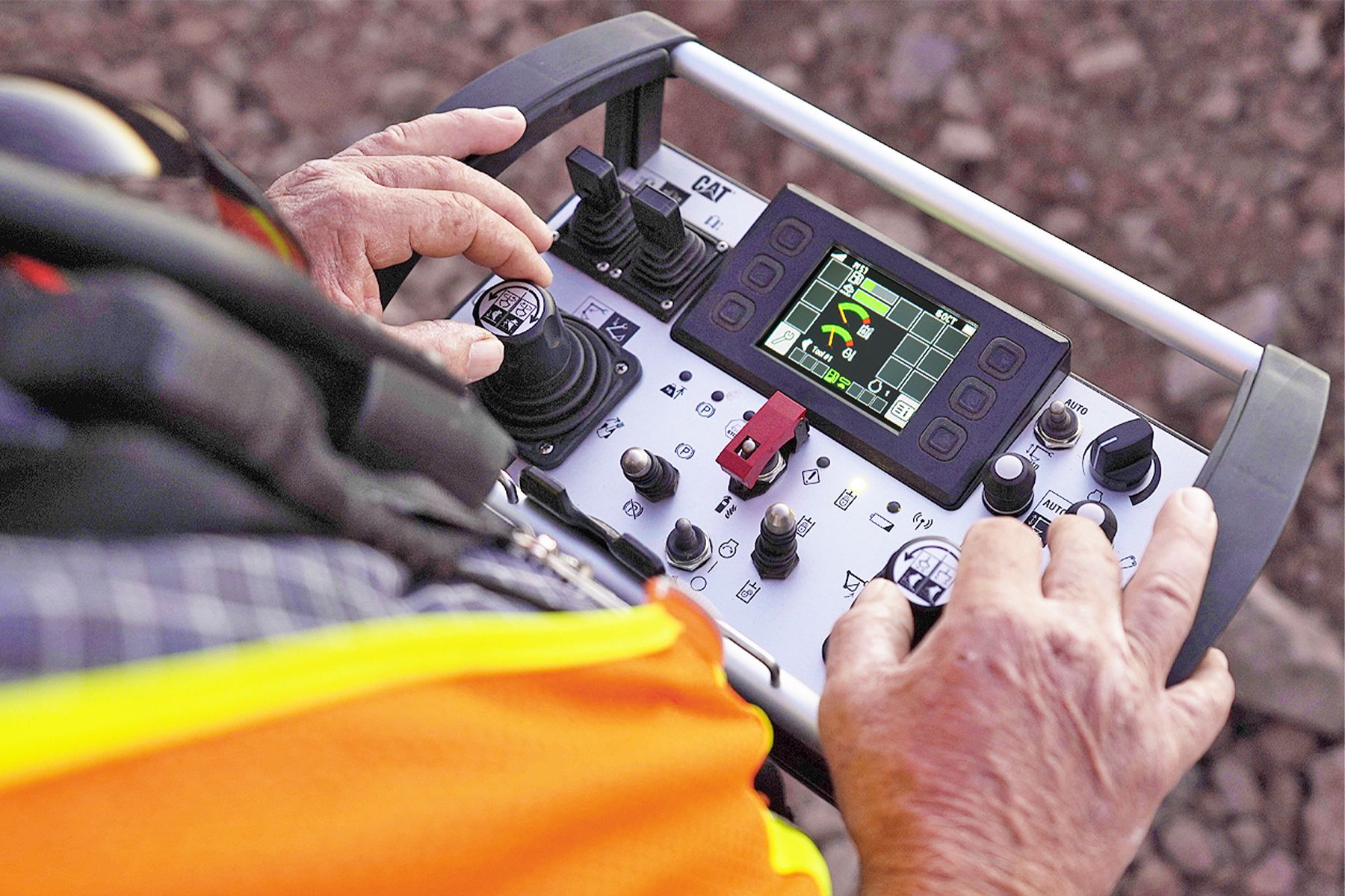 man using remote to control machine